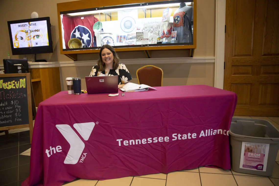 YMCA staff member smiles and welcomes guests